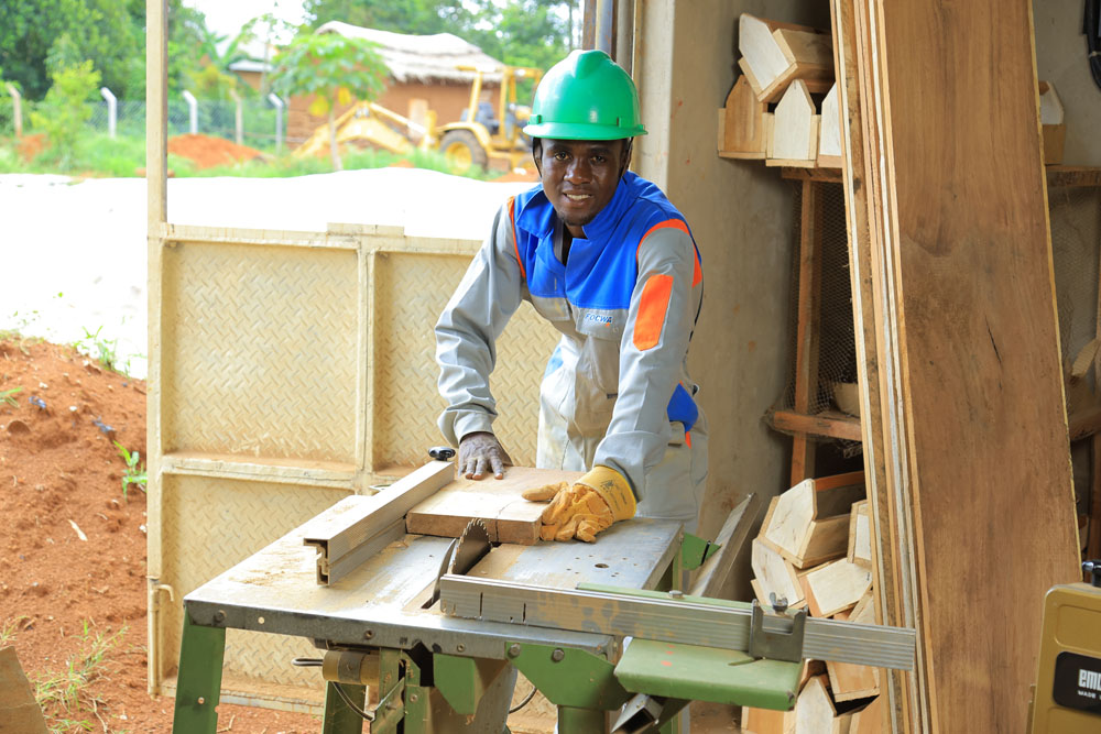 houtbewerker-aan-het-werk-tonny-mukisa-timmerwerkplaats-equip-ngo-oeganda